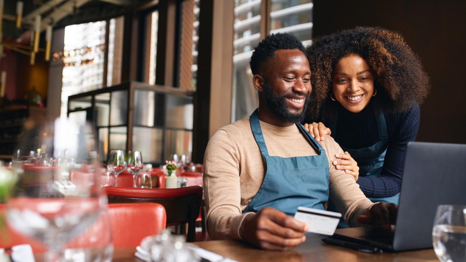 Restaurant Owner with a credit card making a purchase.