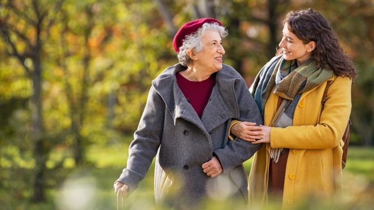 Grandmother with granddaughter in a park.