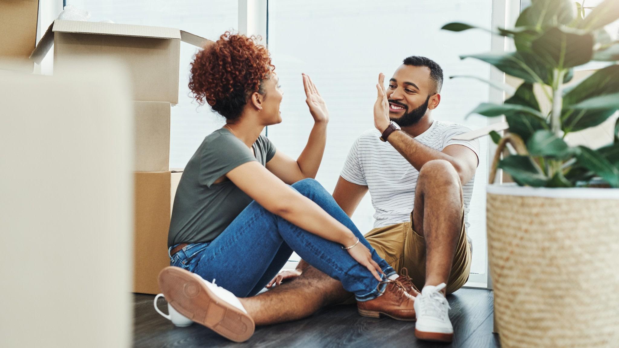 Young couple moves into their new home.